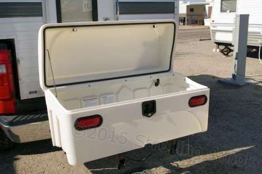 The lid is held on with three slide-in plastic pins, and can stay open on its own. I included a stay bar to prevent wind trying to blow the lid opening further and damaging the hinges. When not engaged, it hangs clumsily from the lid. Overall value: debatable. The sealing gasket is apparent in this shot.