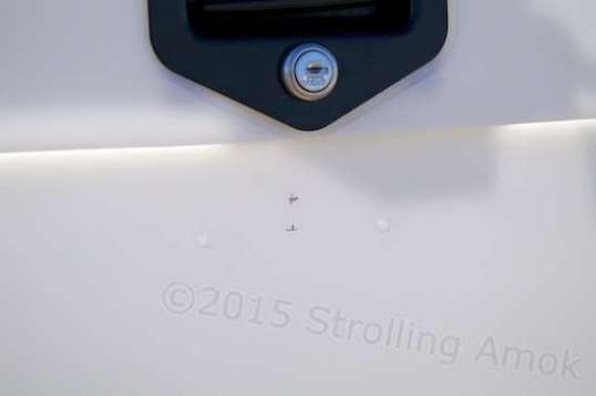 There are two dimples in the wall for drilling and mounting the included lighted license plate holder. There is supposed to be a third for passing wire through to the inside of the box and its wiring harness, but it was missing. It was an easy matter to measure and locate the third, and drill.
