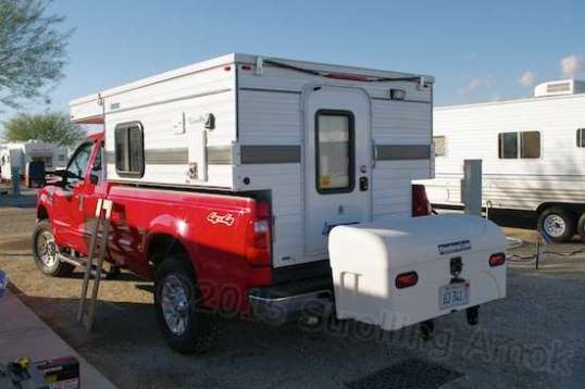 That thing is really perched out there, isn't it? Those are optional wheels underneath, to allow much easier moving around when removed from the hitch. I'll probably leave them on until they pose a ground clearance issue, and the odds are pretty good that they will, I'd say. With a wrench, it takes about three minutes.