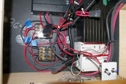 Ack. To the left are two distribution blocks, one positive and one negative. To right is the mighty TriStar controller. In front of it is the toggle switch for the BLS, and an unused switch that coule be used for landing lights or arming the photon beam generators. ;-)