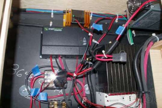 Okay, so wiring things up is not going to be a career option for me. The BLS desulfator is the gold thing at the top, and the Smart Harvest controller is below it. The device to the right with a fan is the camper's multistage shore power battery charger.