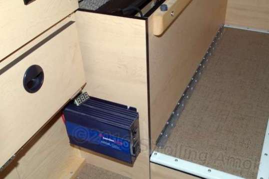 With the Samlex inverter mounted out of the way but accessible, its new supply wires run along a slight gap and then back to the distribution blocks.