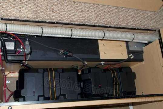 Oh, the humanity! The benches are still presenting good, usable space, but those battery cases eat up cubic feet, not inches. The opposite bench is similar, but has no OEM electronics in it.