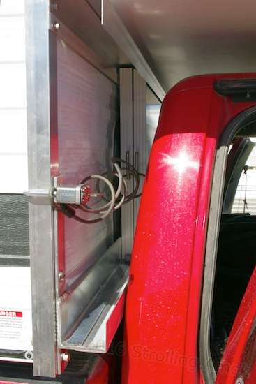 A bike cable keeps tension on the panels, though an appropriate-length straight cable would do just as well. I already had this one.