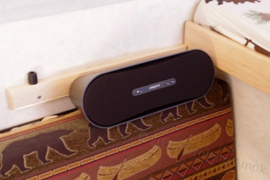 The Creative Labs D100. A wireless pairing button is at left of center, while volume buttons are toward the right.