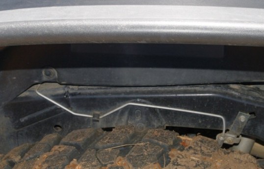 I was surprised to see this rear brake line routed to the outside of the frame, since the chance of a flat tire or whirling tire chains could take out the rear brakes. The installation hardware looks factory, so I'll assume that this feature is Jeep's, and AEV chose not to alter it.