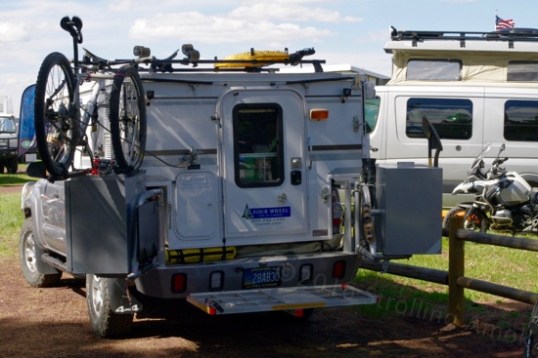 Same rig. Once the Aluminess system is swung open, the hitch platform serves as a step to enter the camper. What other purpose it serves I don't know. Maybe a chair deck to stay out of the mud.