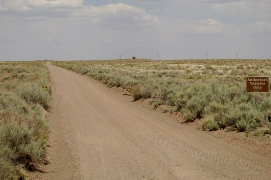The road in is one large "U" that crosses over route 66 twice, not once. This service road, authorized vehicles only, heads off east on the initial trip in, and stays parallel with I-40. Further, my GPS announced it as "66 Road". The 66 memorial is several miles west, as the entry road crosses over it again.