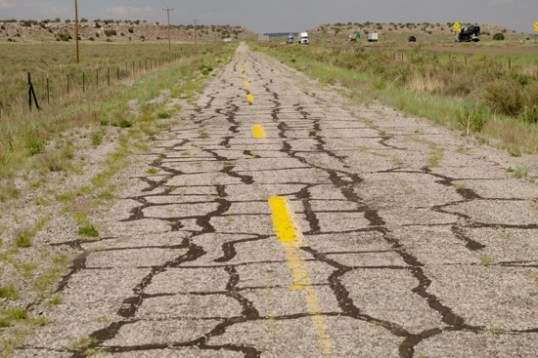 Whoops! Then not so great pavement. Except for normal crack sealing, this is pretty untouched. You can see the left lane edge being seriously encroached by plants. Mixed feelings as I rode down this, and it's still there and usable, but is going away.