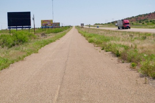 This piece of 66 was sun-baked and encroached by plants, but still in business. Judging by the faded paint stripes, it's been awhile.