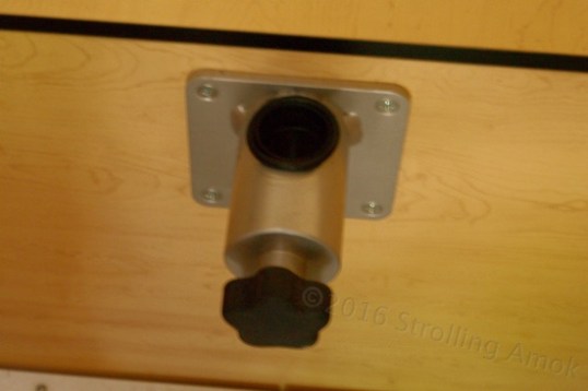 Not my best photo. The black blob on top is a through-hole, and the knob in front slides a massive internal surround that moves progressively farther off-center to build friction on the pole.