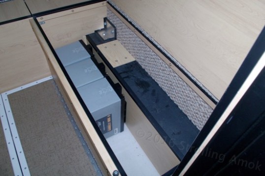 The passenger-side bench while goofing around with basic fit issues. All four AGMs squeeze easily into one bench, but the wiring and access quickly become an issue, which is a shame. With enough huffing and puffing, I can get them in and out, but cabling and service become a nightmare.