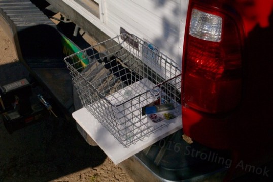 I call it the "poo bag basket", but it's also handy for hauling trash bags and general "hold this for a minute" uses. It's bolted to a thick steel tailgate support bracket.